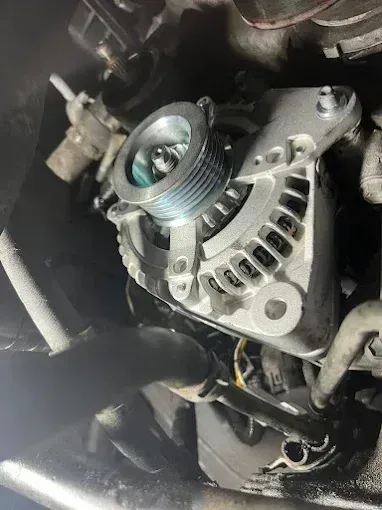 Alternator in the engine bay during an auto electrical repair