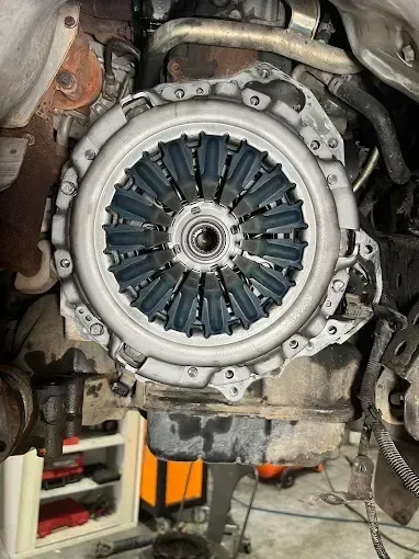 Clutch pressure plate exposed with the gearbox removed during a clutch replacement