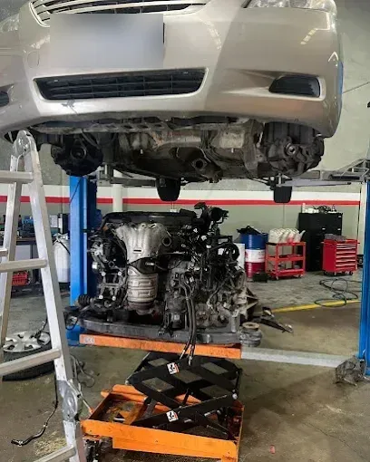 Engine lowered out from under a car on a hoist during an engine replacement