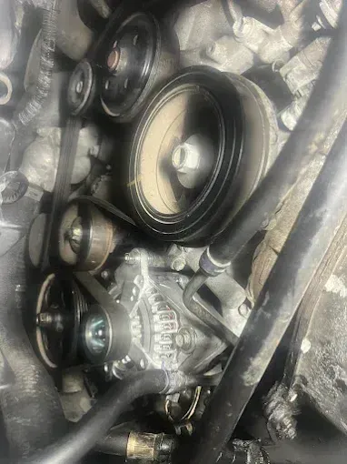 Front of an engine showing the drive belt pulleys and accessories