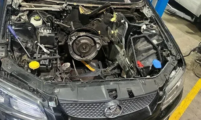 Holden engine bay with the engine removed during an engine replacement