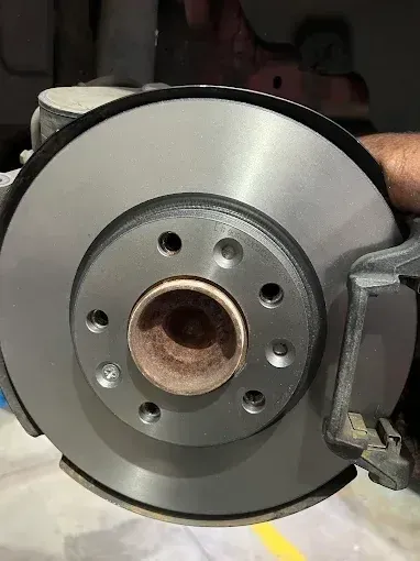 New brake disc being fitted to the wheel hub