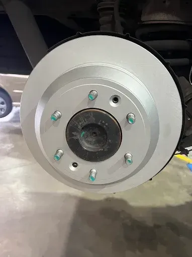 New brake disc fitted to a vehicle at P&J Automotive