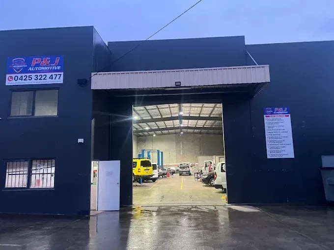 P&J Automotive workshop at 24 Harvester Ave, Sunshine North, with the roller door open and business signage