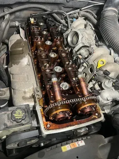 Cylinder head with camshafts and timing chain exposed during timing chain work